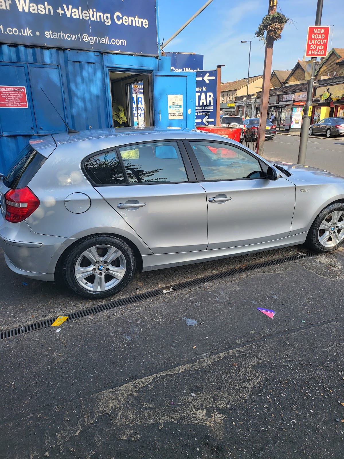 Mechanic working underneath a car on the ramp at 5 Star Hand Car Wash and Valeting